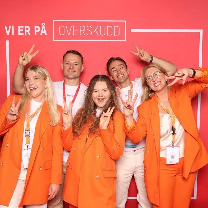 Five Kravia colleagues in orange at a company event
